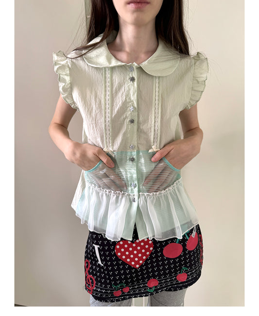 Unsocial Night short sleeve shirt showcasing the sheer mesh panel inserts, central button closures, slim-fit tailoring, and structural flutter sleeves