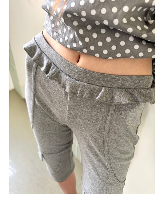 Unsocial Night fitted biker shorts showcasing the contrast patchwork seams, slim-fit technical fabric, and custom sparkling rhinestone details