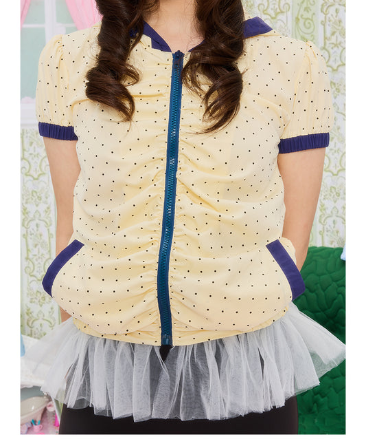 Front view of Unsocial Night short jacket top featuring an all-over polka dot print, a cozy attached hood, short puff sleeves, and a zip-up closure.