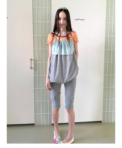 Unsocial Night fitted biker shorts showcasing the contrast patchwork seams, slim-fit technical fabric, and custom sparkling rhinestone details