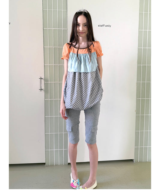 Unsocial Night fitted biker shorts showcasing the contrast patchwork seams, slim-fit technical fabric, and custom sparkling rhinestone details