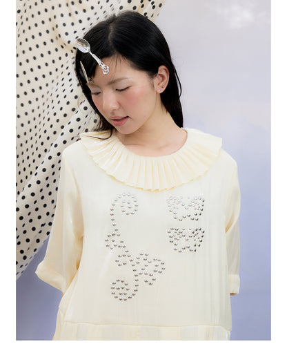 Front view of Unsocial Night beige Shimmer Waves pleated dress featuring an A-line silhouette, classic round neck, half sleeves, and delicate rhinestone embellishments
