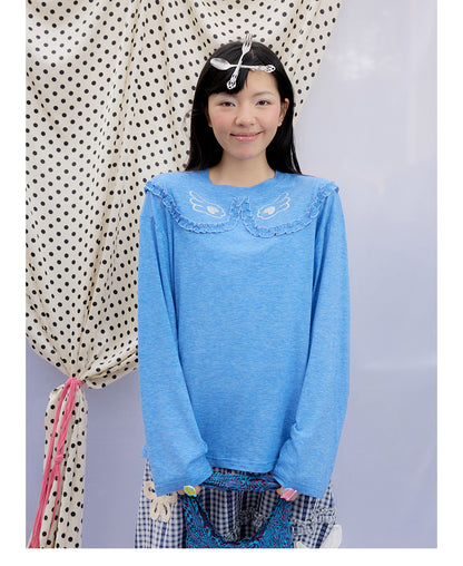 Front view of Unsocial Night blue ruffles tee top featuring a relaxed oversized silhouette, a classic crewneck, long sleeves, and paneled patchwork detailing