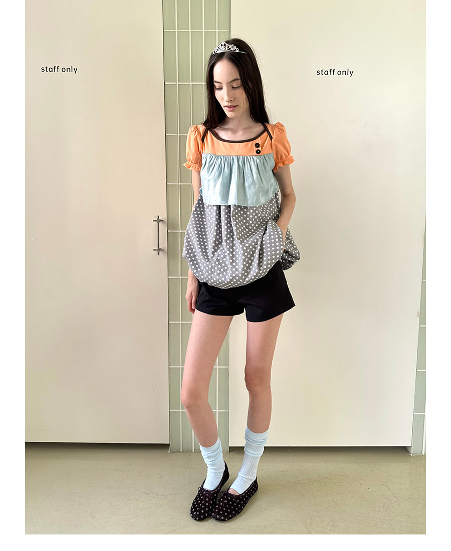 Unsocial Night short sleeve top showcasing a whimsical polka dot print, structured puff sleeves, contrast patchwork, and a voluminous bubble hem