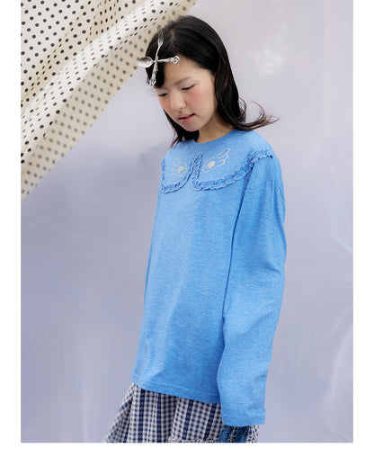 Front view of Unsocial Night blue ruffles tee top featuring a relaxed oversized silhouette, a classic crewneck, long sleeves, and paneled patchwork detailing
