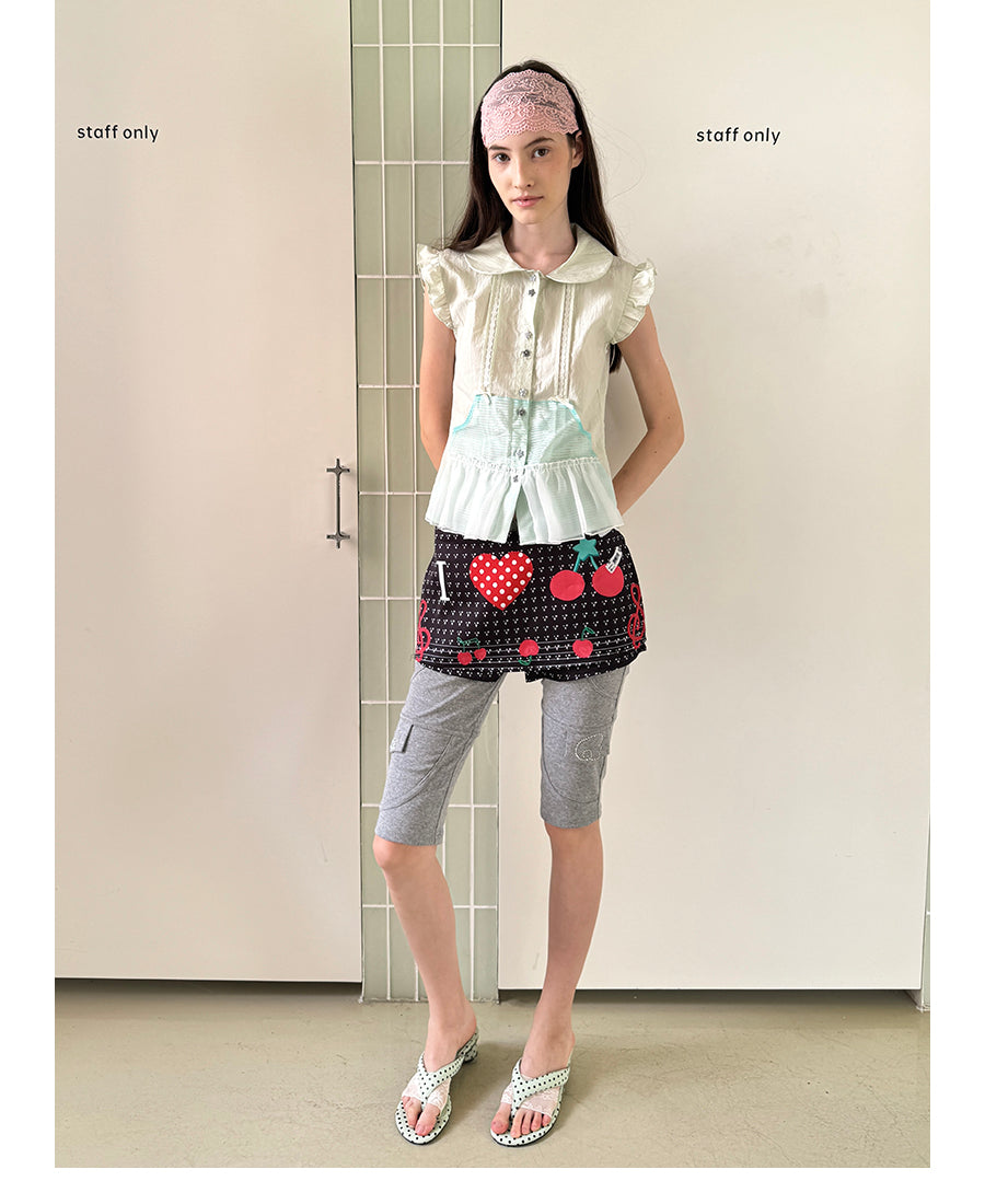 Unsocial Night short sleeve shirt showcasing the sheer mesh panel inserts, central button closures, slim-fit tailoring, and structural flutter sleeves