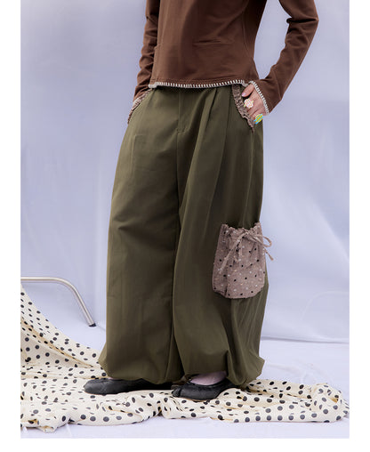 Front view of Unsocial Night moss green cargo pants featuring a paperbag waist silhouette, utility pockets, zipper fly, and textured cotton-linen fabric
