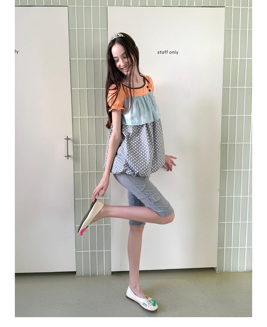 Unsocial Night fitted biker shorts showcasing the contrast patchwork seams, slim-fit technical fabric, and custom sparkling rhinestone details
