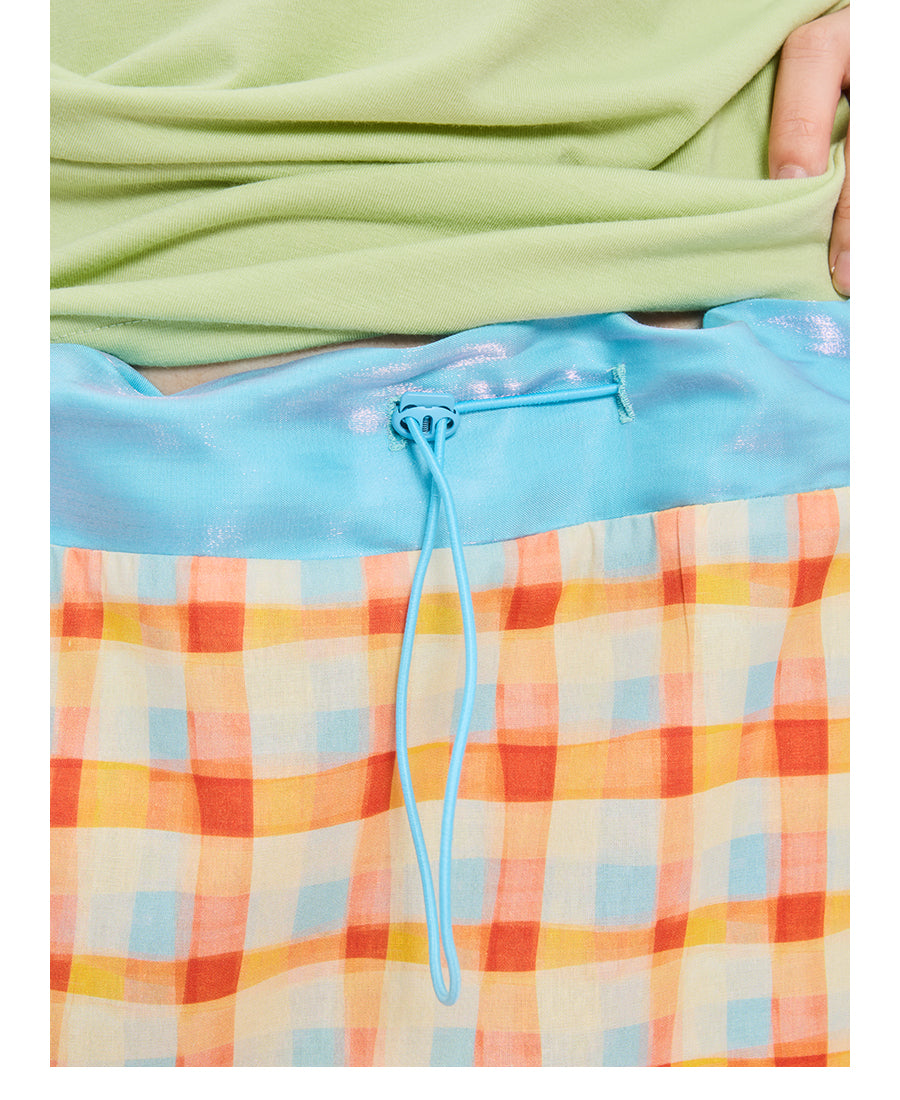 Front view of Unsocial Night orange color block plaid drawstring tube skirt top showing its convertible H-line silhouette, elastic waist, and patchwork details