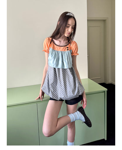 Unsocial Night short sleeve top showcasing a whimsical polka dot print, structured puff sleeves, contrast patchwork, and a voluminous bubble hem