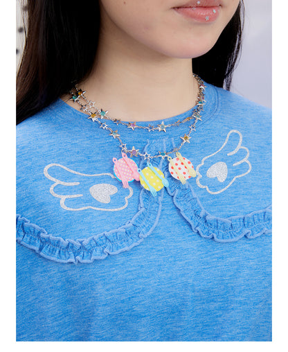 Front view of Unsocial Night blue ruffles tee top featuring a relaxed oversized silhouette, a classic crewneck, long sleeves, and paneled patchwork detailing