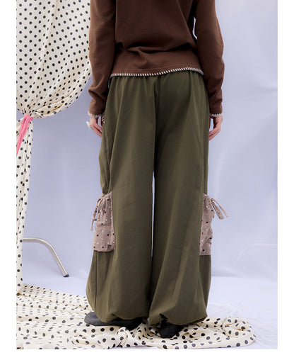 Front view of Unsocial Night moss green cargo pants featuring a paperbag waist silhouette, utility pockets, zipper fly, and textured cotton-linen fabric