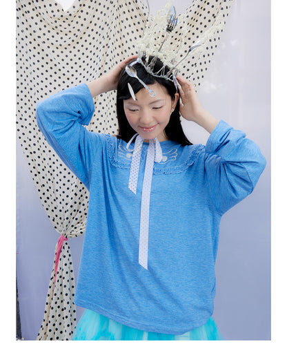 Front view of Unsocial Night blue ruffles tee top featuring a relaxed oversized silhouette, a classic crewneck, long sleeves, and paneled patchwork detailing