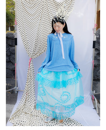 Front view of Unsocial Night blue ruffles tee top featuring a relaxed oversized silhouette, a classic crewneck, long sleeves, and paneled patchwork detailing