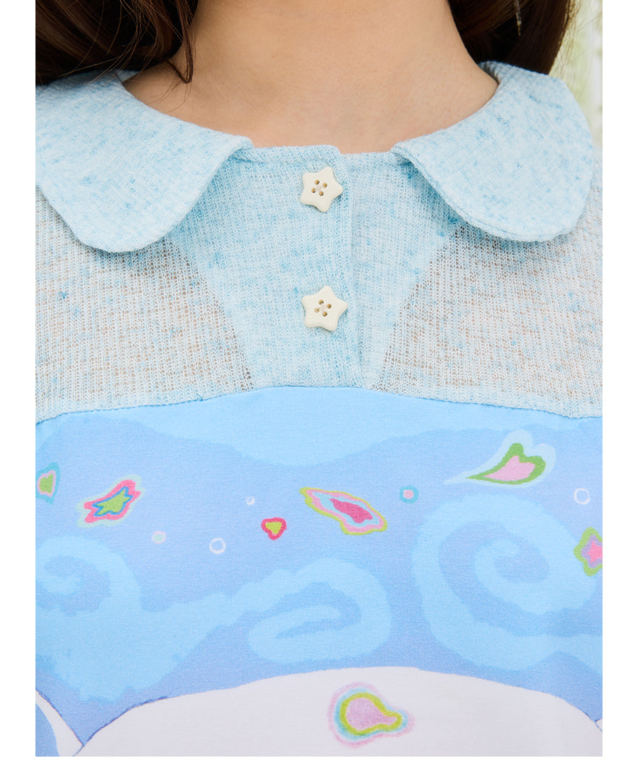 Front view of UnsocialNight Momoko blue girl knit top featuring short puff sleeves, a buttoned neckline, and a vintage graphic print patchwork on premium breathable cotton.