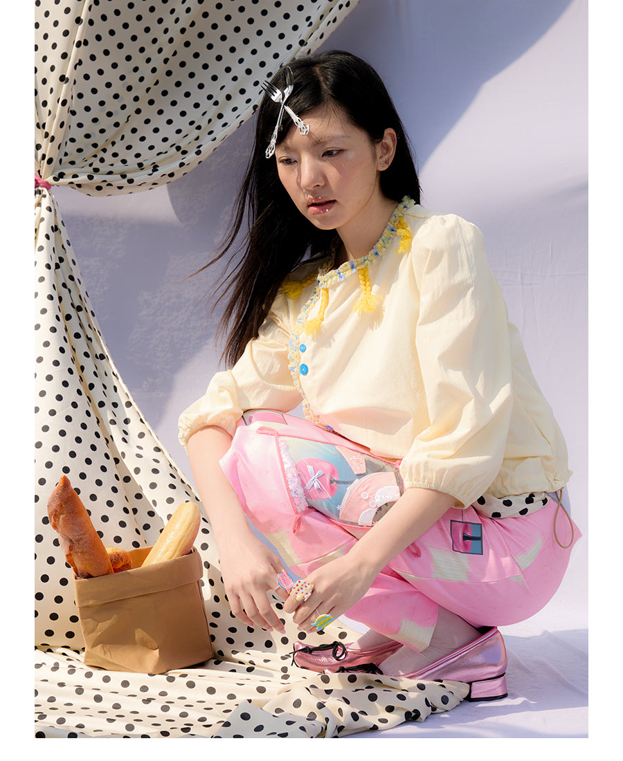 Front view of Unsocial Night pale yellow Wrapped in Lemon Souffle shirt featuring a soft regular fit, short sleeves, split neck with ponytail ties, and panel stitching