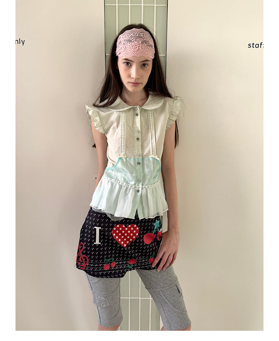 Unsocial Night short sleeve shirt showcasing the sheer mesh panel inserts, central button closures, slim-fit tailoring, and structural flutter sleeves