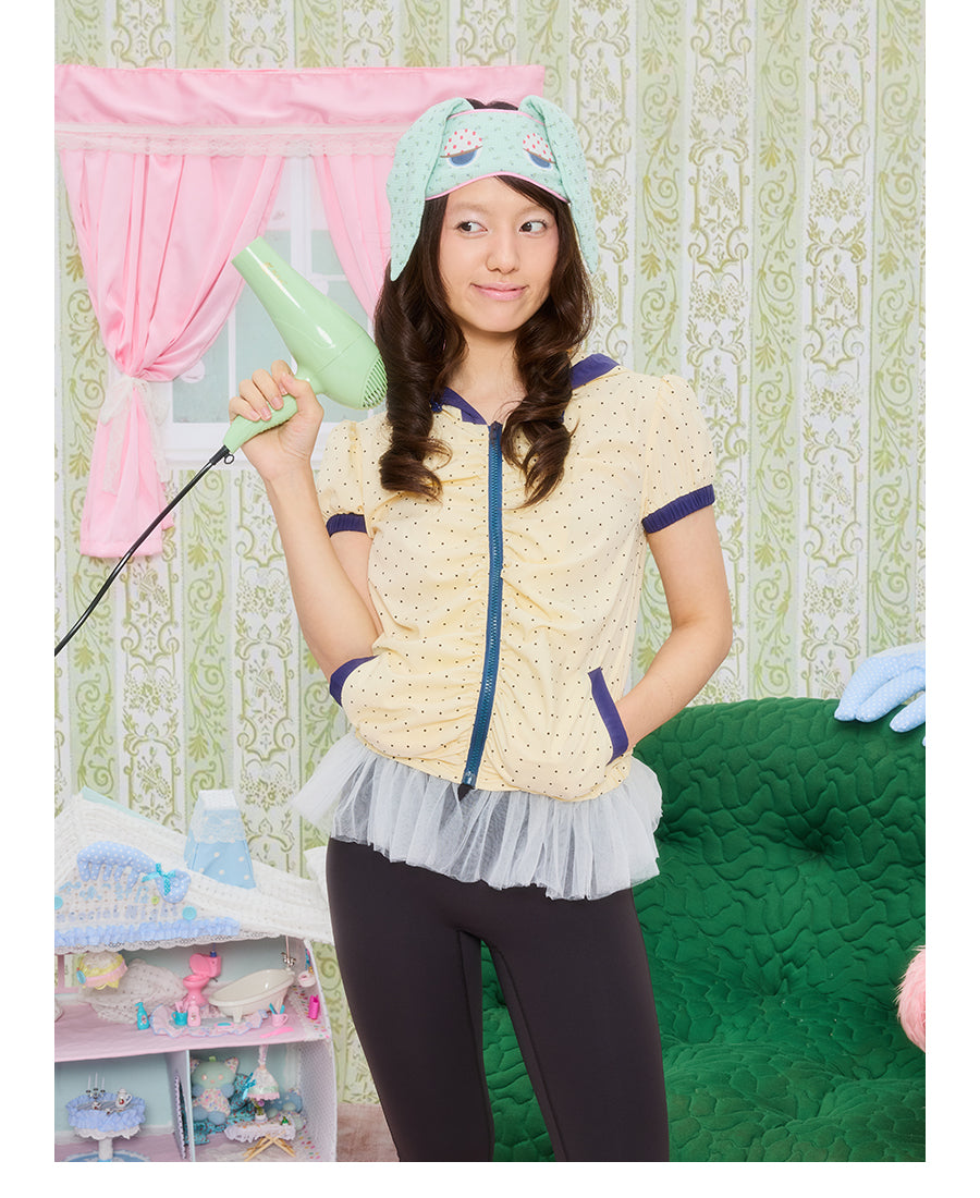 Front view of Unsocial Night short jacket top featuring an all-over polka dot print, a cozy attached hood, short puff sleeves, and a zip-up closure.
