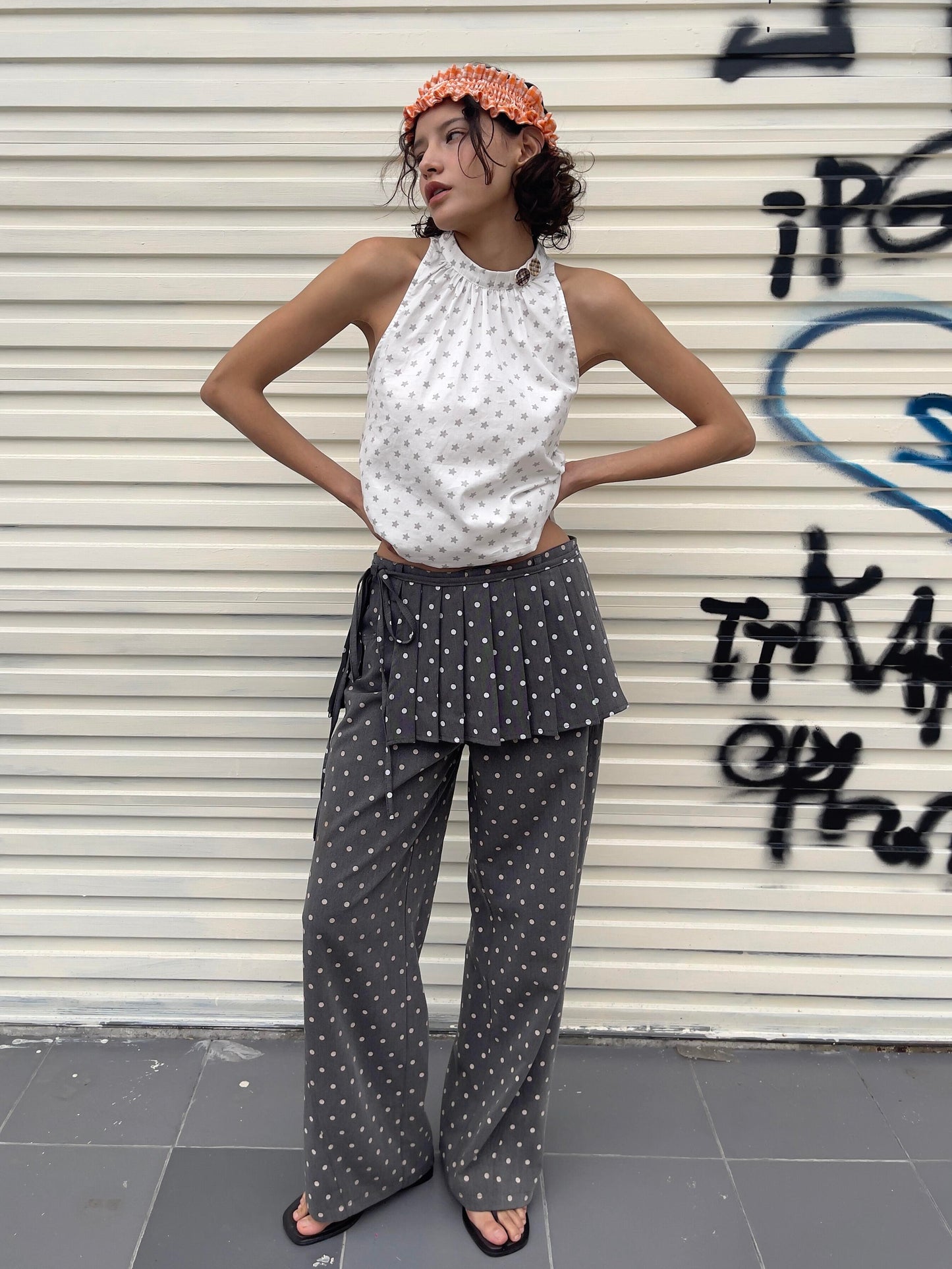 Front view of Unsocial Night pleated polka dots skirt pants 2-piece set showcasing the layered micro-pleated skirt over matching fluid wide-leg trousers