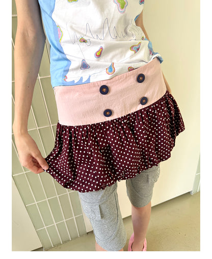 Unsocial Night bubble puff skort showcasing a whimsical polka dot print, contrast patchwork detailing, structured voluminous hem, and internal shorts