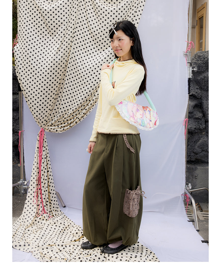 Front view of Unsocial Night moss green cargo pants featuring a paperbag waist silhouette, utility pockets, zipper fly, and textured cotton-linen fabric