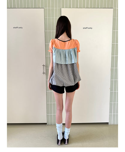 Unsocial Night short sleeve top showcasing a whimsical polka dot print, structured puff sleeves, contrast patchwork, and a voluminous bubble hem