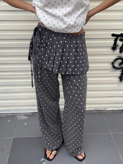 Front view of Unsocial Night pleated polka dots skirt pants 2-piece set showcasing the layered micro-pleated skirt over matching fluid wide-leg trousers