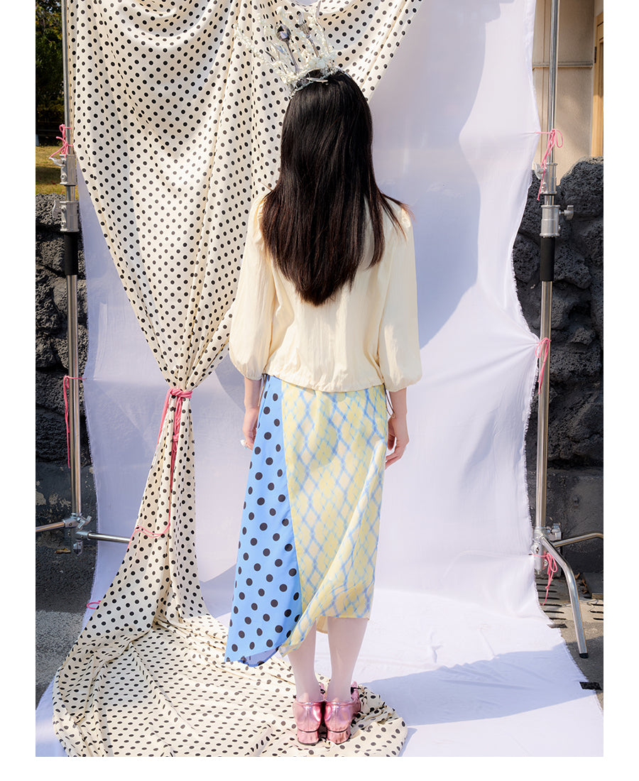 Front view of Unsocial Night Scrapbook Sunday patchwork skirt featuring a mid-rise A-line flare silhouette, contrast paneling, plaid and polka dots patchwork