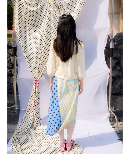 Front view of Unsocial Night Scrapbook Sunday patchwork skirt featuring a mid-rise A-line flare silhouette, contrast paneling, plaid and polka dots patchwork