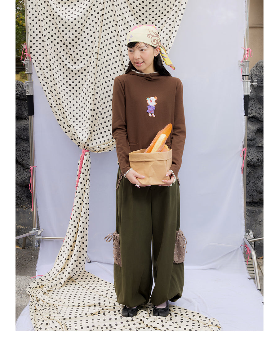 Front view of Unsocial Night moss green cargo pants featuring a paperbag waist silhouette, utility pockets, zipper fly, and textured cotton-linen fabric