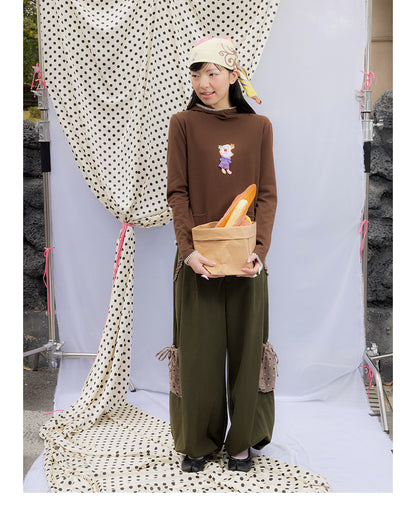 Front view of Unsocial Night moss green cargo pants featuring a paperbag waist silhouette, utility pockets, zipper fly, and textured cotton-linen fabric