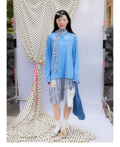 Front view of Unsocial Night blue ruffles tee top featuring a relaxed oversized silhouette, a classic crewneck, long sleeves, and paneled patchwork detailing