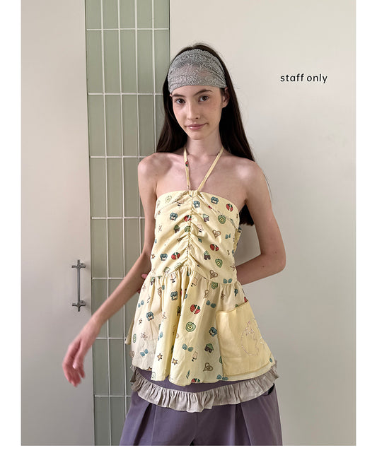 Unsocial Night strapless tube top showcasing a whimsical naive-art illustration print, central front detailing, and adjustable ribbon halter ties
