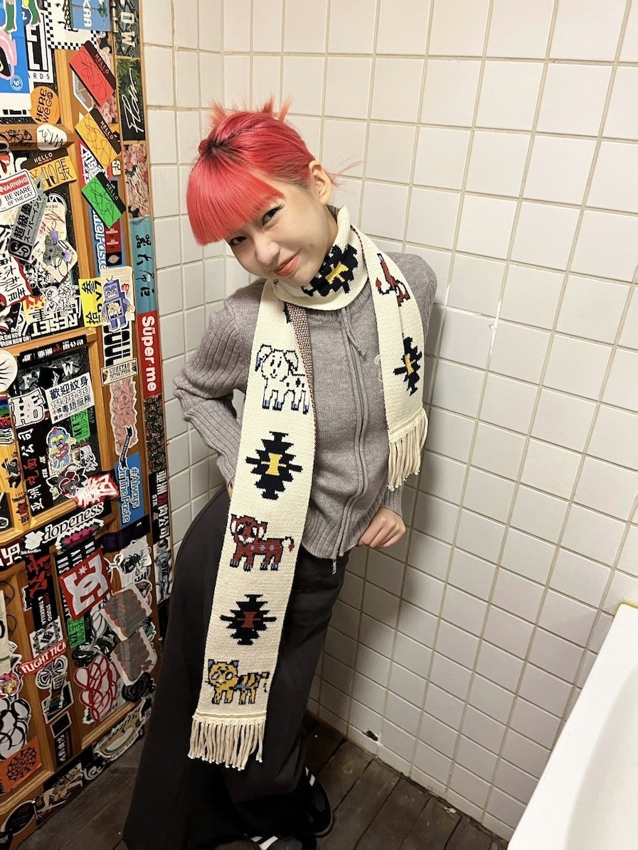 Front view of Unsocial Night illustrated animal knit scarf showcasing the custom jacquard graphic motif, soft ribbed knit texture, and long twisted fringe edges