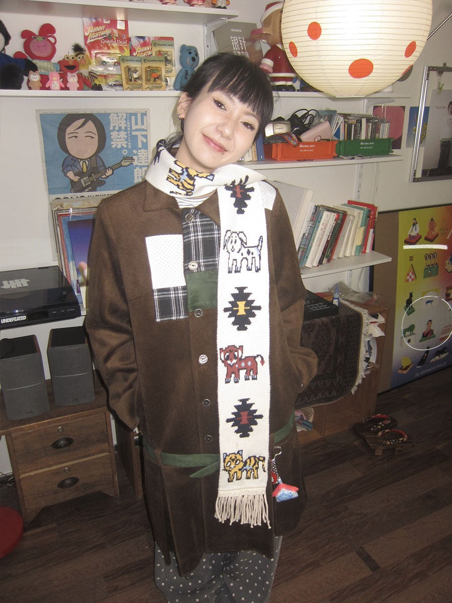 Front view of Unsocial Night illustrated animal knit scarf showcasing the custom jacquard graphic motif, soft ribbed knit texture, and long twisted fringe edges