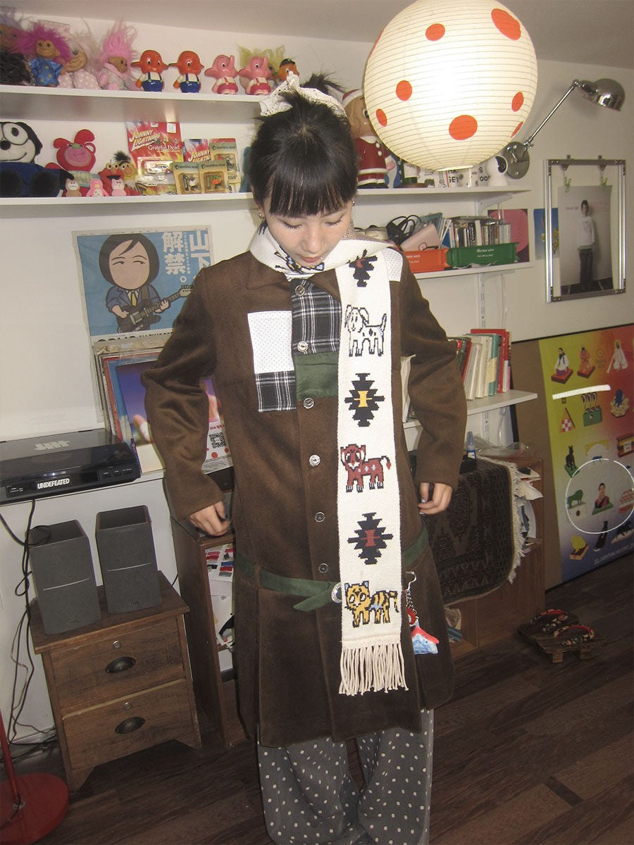Front view of Unsocial Night illustrated animal knit scarf showcasing the custom jacquard graphic motif, soft ribbed knit texture, and long twisted fringe edges
