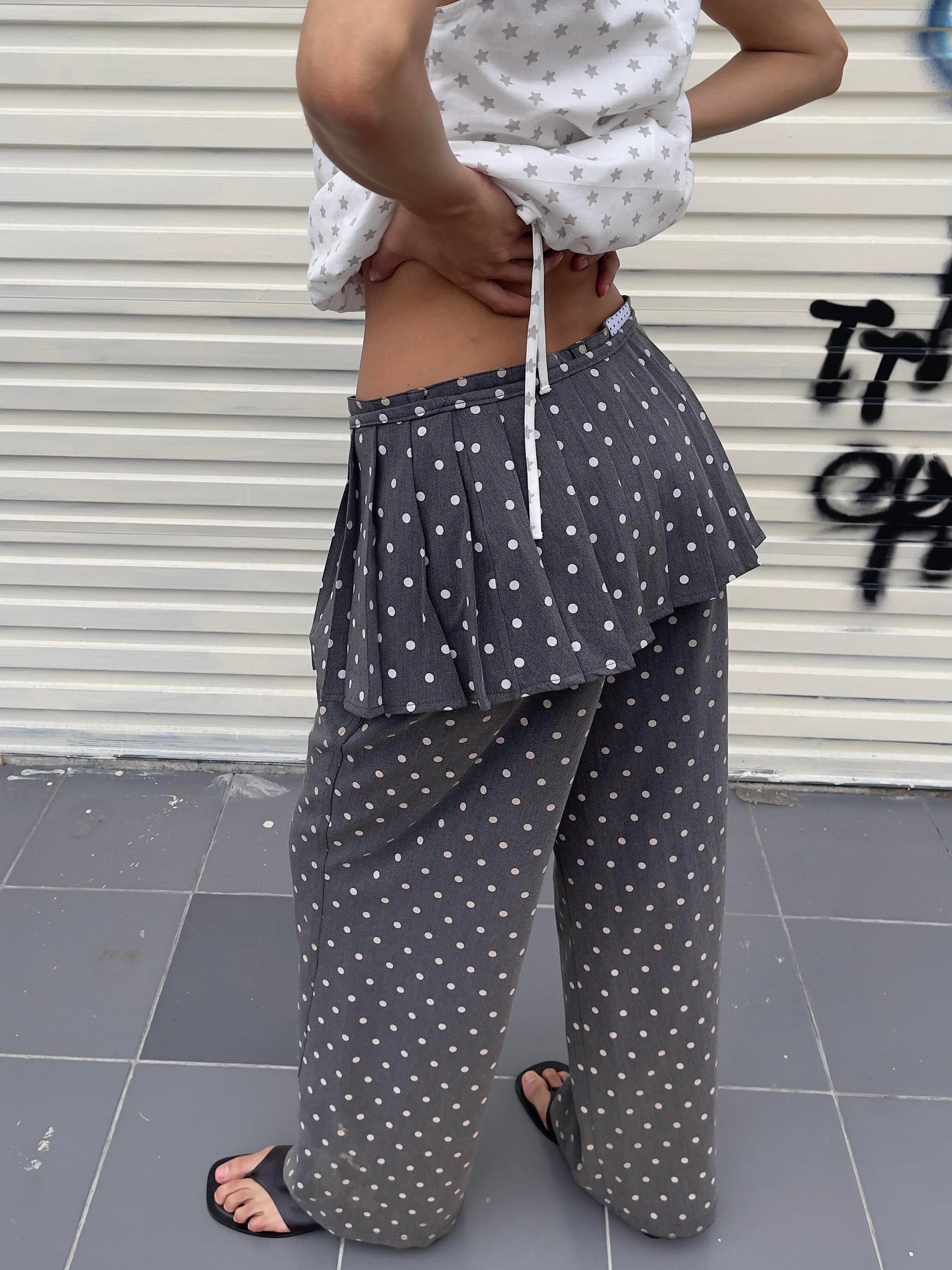 Front view of Unsocial Night pleated polka dots skirt pants 2-piece set showcasing the layered micro-pleated skirt over matching fluid wide-leg trousers